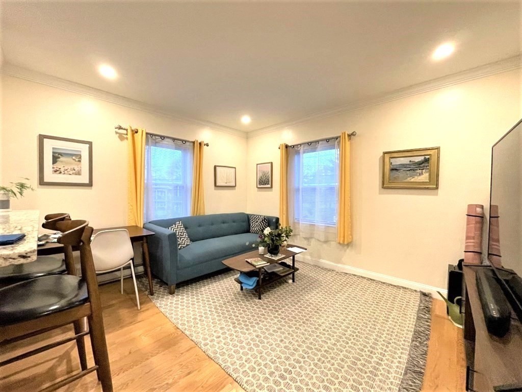 31 Cedar Street, Unit 1 Cambridge, MA 02140 - Photo 3 of 5 a living room with furniture and a flat screen tv