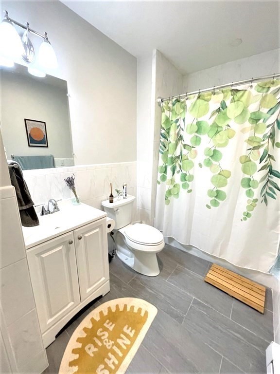 31 Cedar Street, Unit 1 Cambridge, MA 02140 - Photo 5 of 5 a living room with a bed and a table