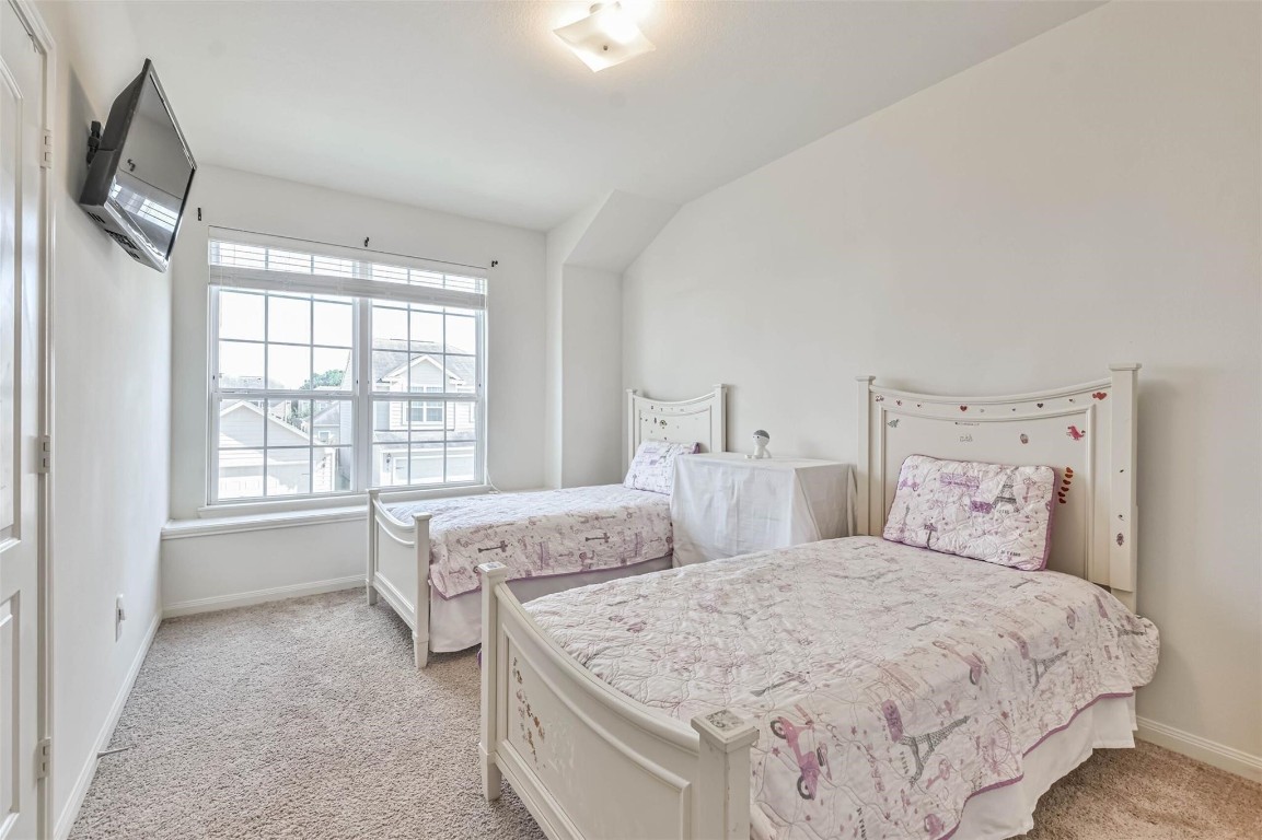 2050 Wilde Elm Houston, TX 77090 - Photo 16 of 19 a spacious bedroom with two beds and a window
