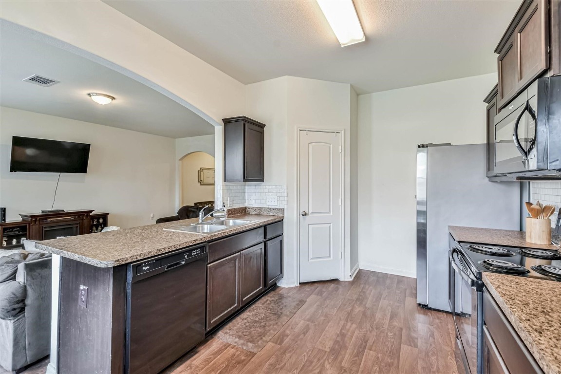 2050 Wilde Elm Houston, TX 77090 - Photo 7 of 19 a kitchen with a stove and a sink