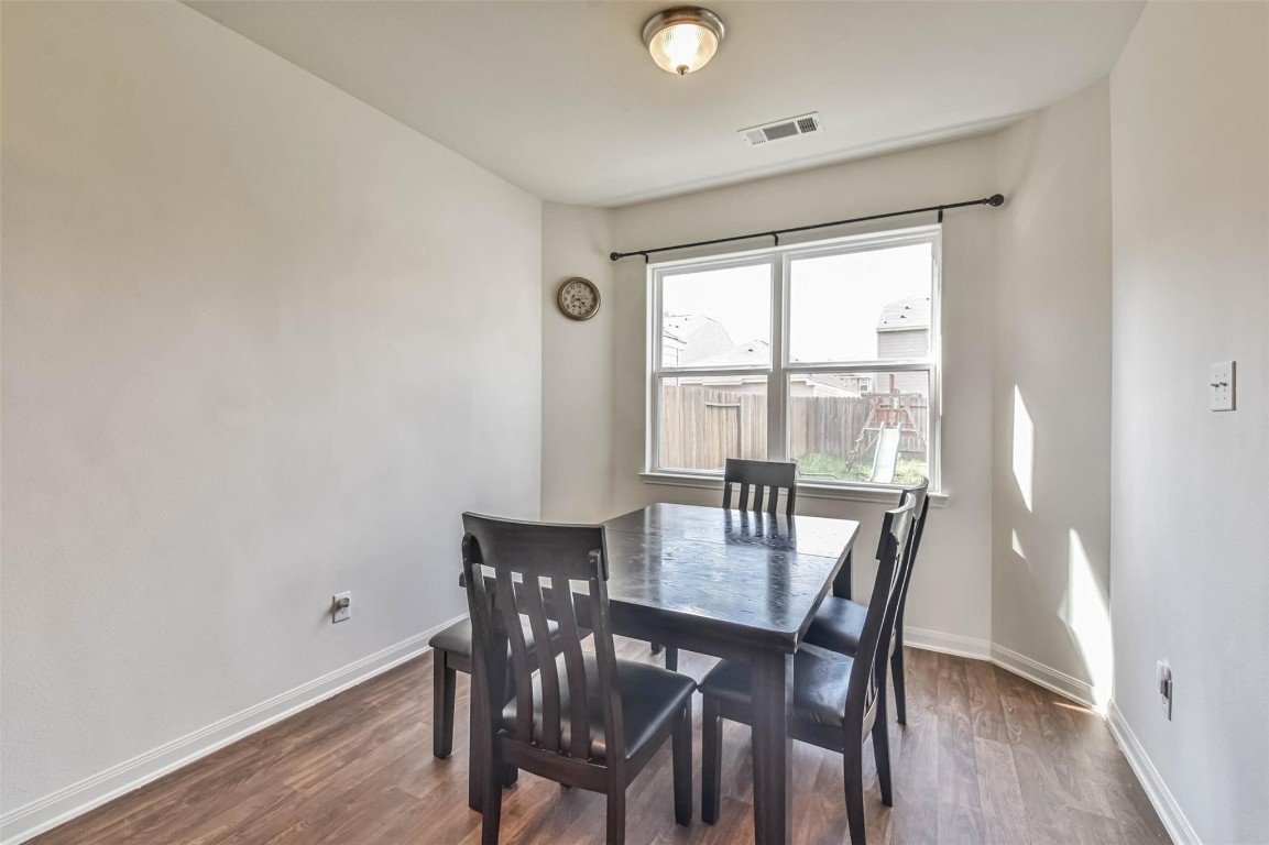2050 Wilde Elm Houston, TX 77090 - Photo 9 of 19 a view of a dining room with furniture and wooden floor
