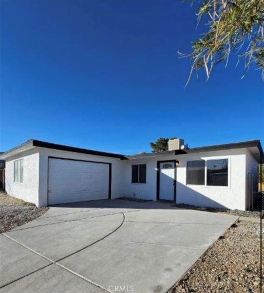 1813 Sunrise Road Barstow, CA 92311 - Photo 1 of 1 a front view of a house with a garage