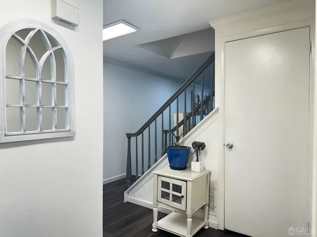 a view of entryway and hall with wooden floor