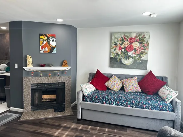 a living room with furniture and a fireplace