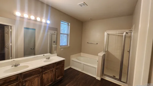 a bathroom with a double vanity sink a toilet and a mirror
