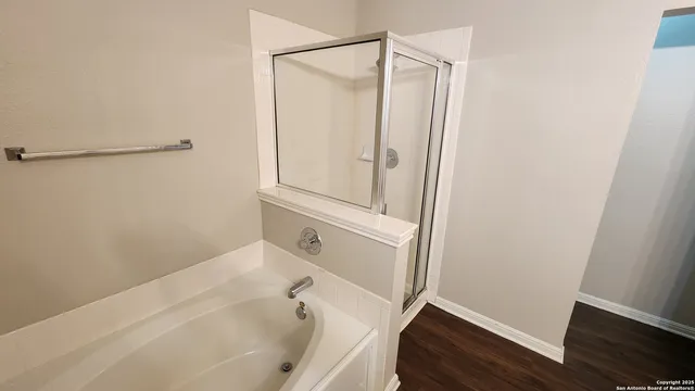 a bathroom with a bathtub and a shower