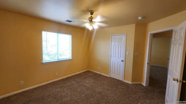 a view of a bathroom with a sink and a mirror