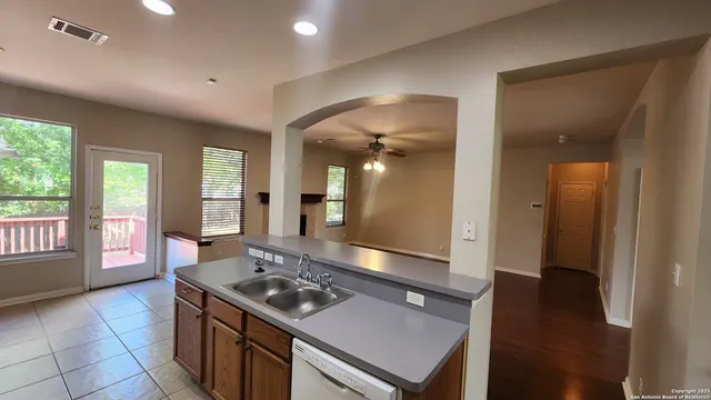 a kitchen with a stove and a wooden floor