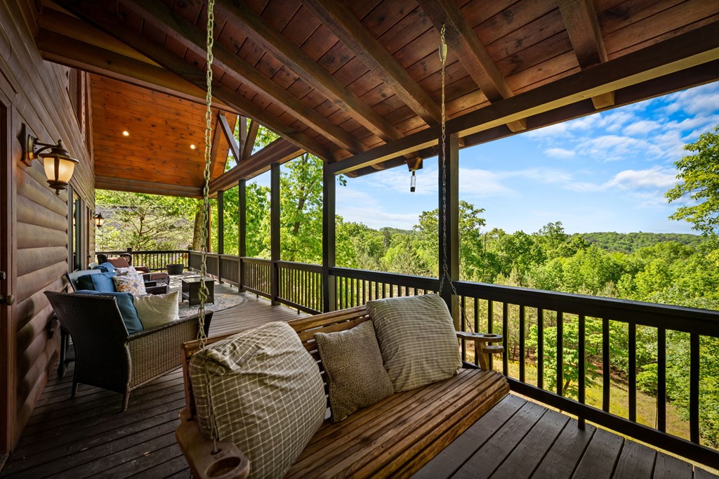 479 Big Timber Road Mineral Bluff, GA 30559 - Photo 45 of 60 a balcony with furniture and wooden floor