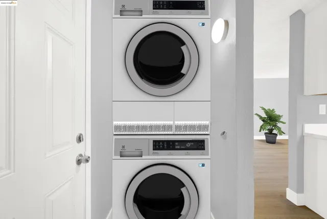 a kitchen with a sink dishwasher stove and white cabinets