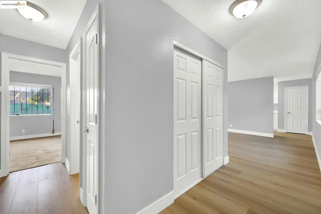 an empty room with windows and closet