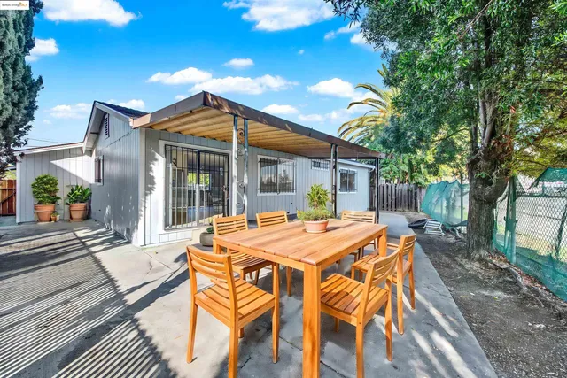 a view of a house with a backyard and garage