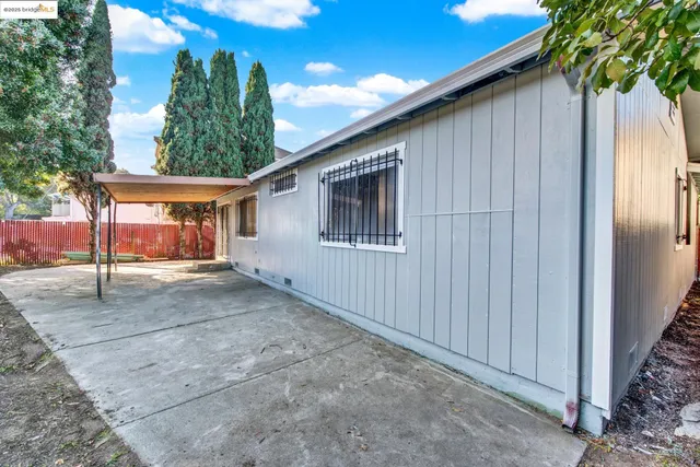 a view of a street with wooden fence