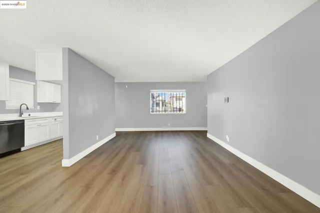 a view of a kitchen with wooden floor and electronic appliances