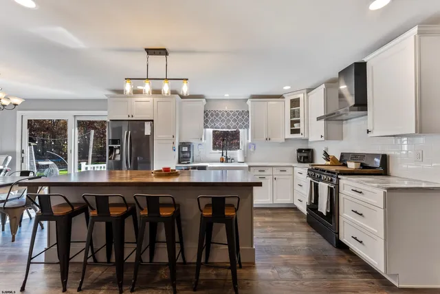 a view of a dining room with furniture wooden floor and chandelier