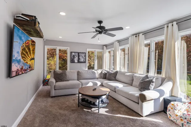 a living room filled with furniture and a chandelier