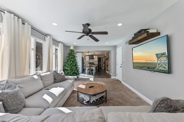 a bedroom with a bed a chandelier and a dresser