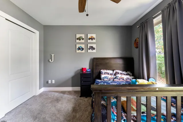 a spacious bedroom with a bed and a flat screen tv