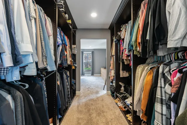 a front view of a house with yard tree and wooden fence