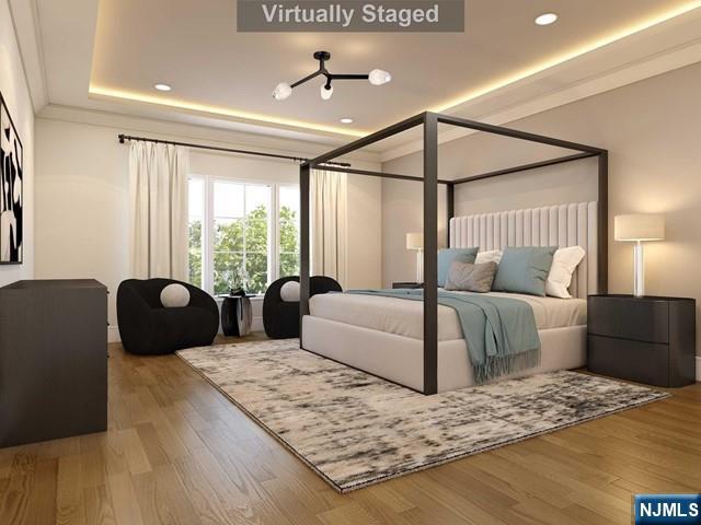 645 Summit Street Englewood Cliffs, NJ 07632 - Photo 12 of 33 a bedroom with a large bed and a large window