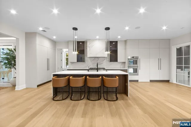 a view of a hardwood floor and windows in a room