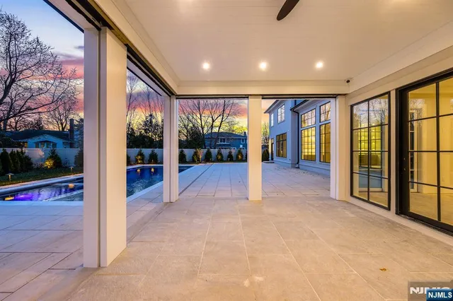 a bedroom with a bed and glass door