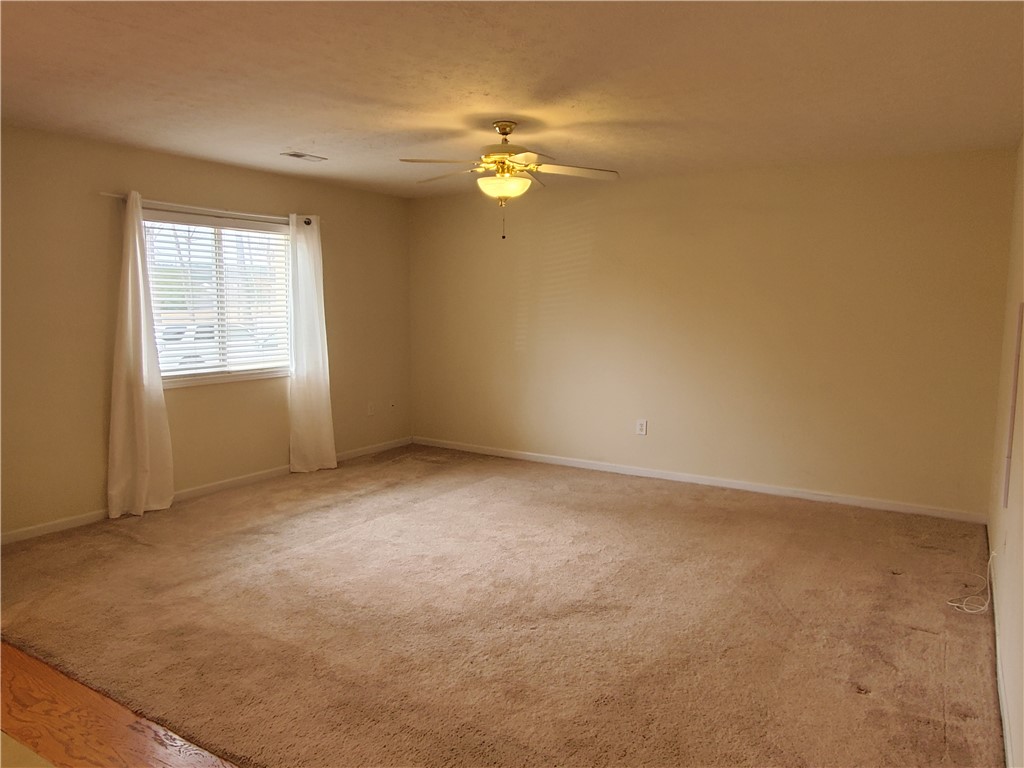 123 Perkins Place Seneca, SC 29678 - Photo 3 of 20 This versatile room offers comfortable carpeting and a bright window, perfect for any use.