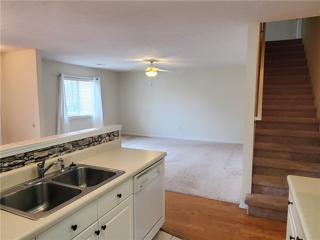 123 Perkins Place Seneca, SC 29678 - Photo 6 of 20 This inviting interior features a well-appointed kitchen, an open living space, and convenient access to the upper level.