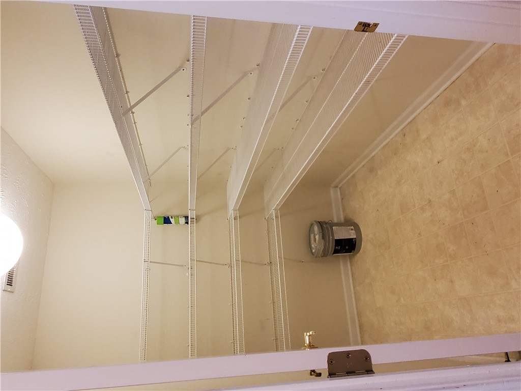 123 Perkins Place Seneca, SC 29678 - Photo 9 of 20 This spacious utility area features ample shelving and durable flooring for functional storage solutions.