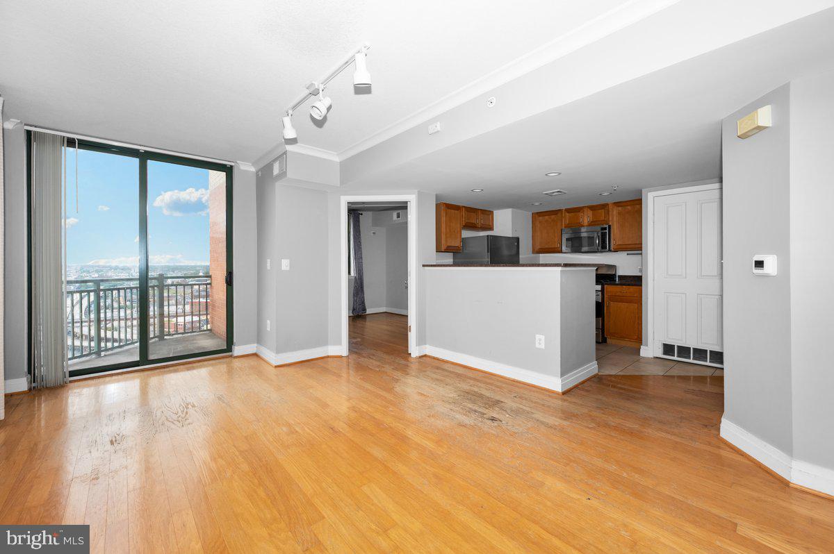 414 Water Street, Unit 2805 Baltimore, MD 21202 - Photo 8 of 26 a view of a kitchen with a sink and a large window