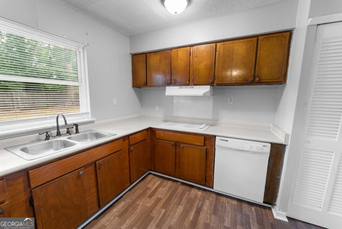 320 West Whatley Street Pooler, GA 31322 - Photo 21 of 34 a kitchen with a sink wooden cabinets and a window
