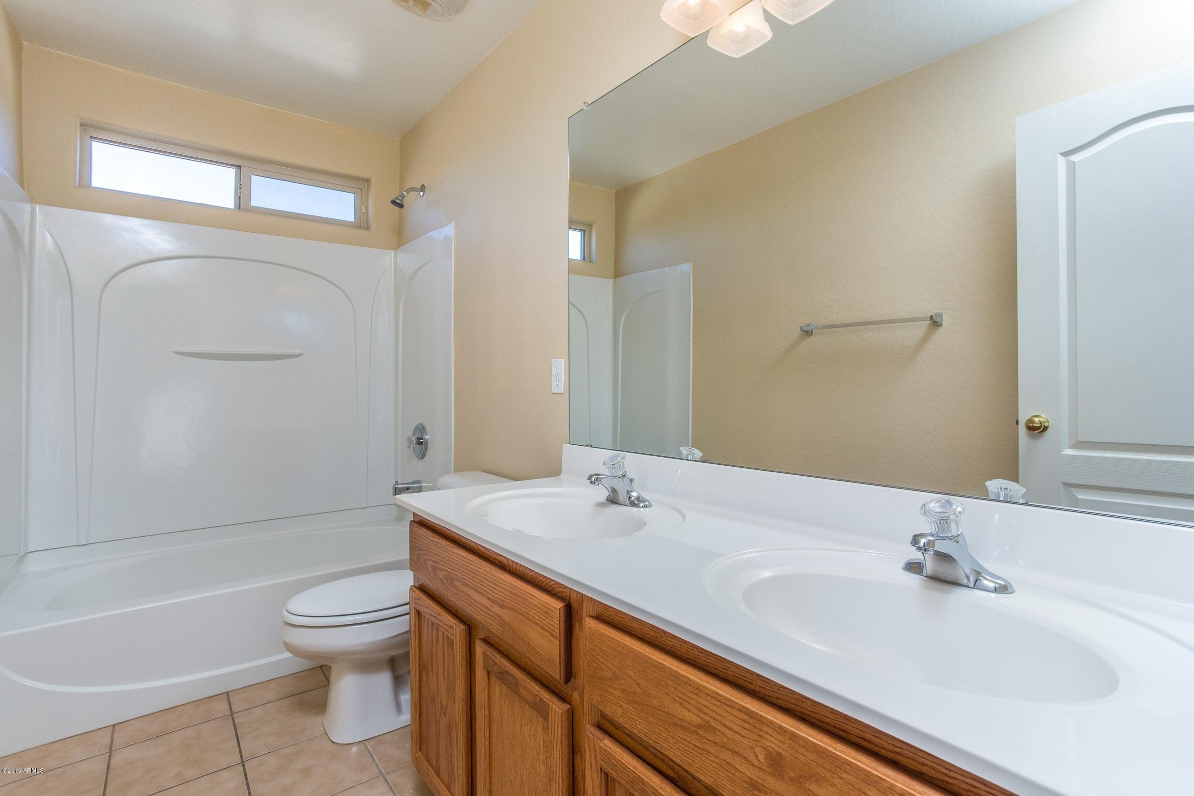 7326 West Darrel Road Laveen, AZ 85339 - Photo 13 of 15 a bathroom with a sink a toilet and shower