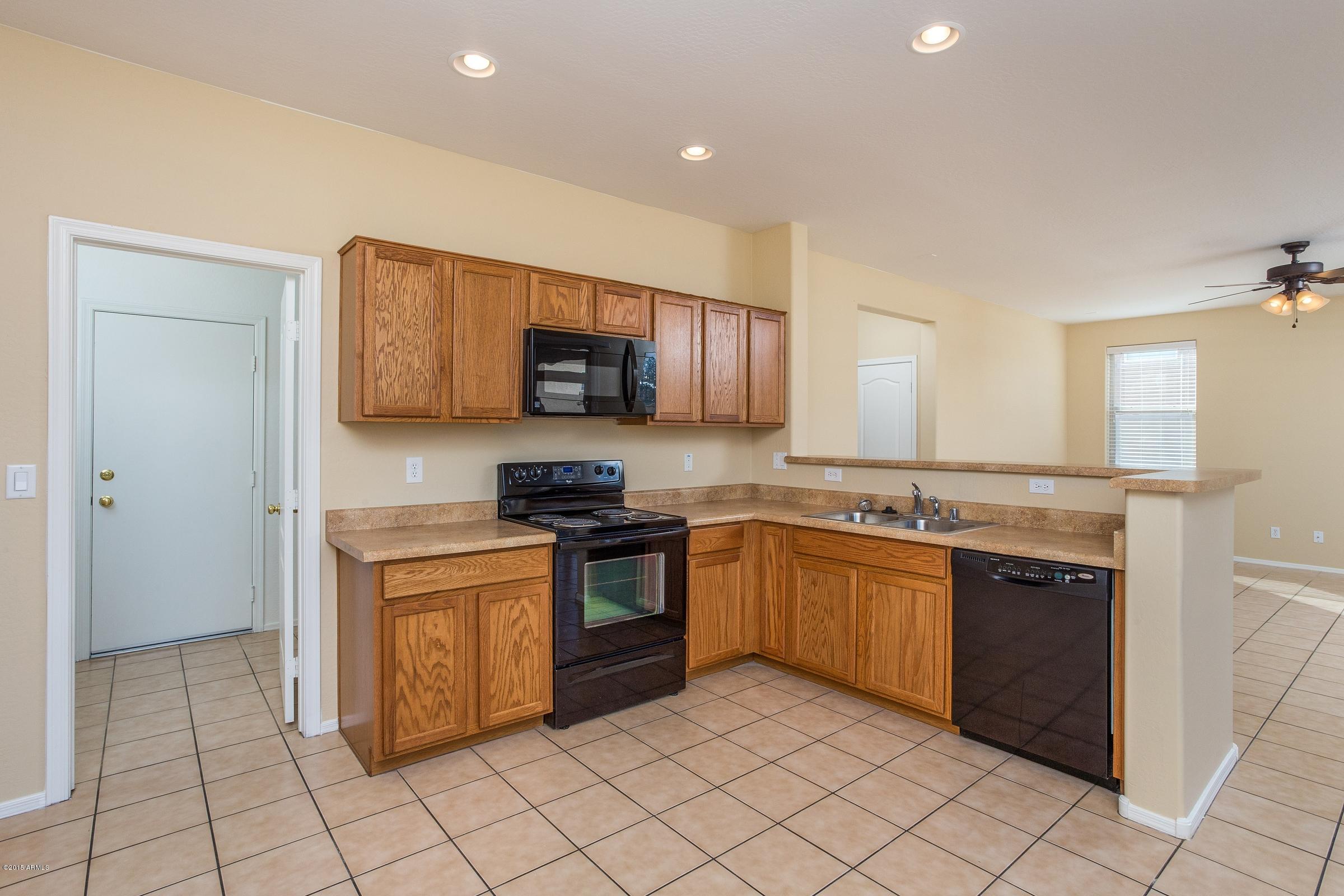 7326 West Darrel Road Laveen, AZ 85339 - Photo 6 of 15 a kitchen with stainless steel appliances granite countertop a stove top oven a sink dishwasher and a refrigerator