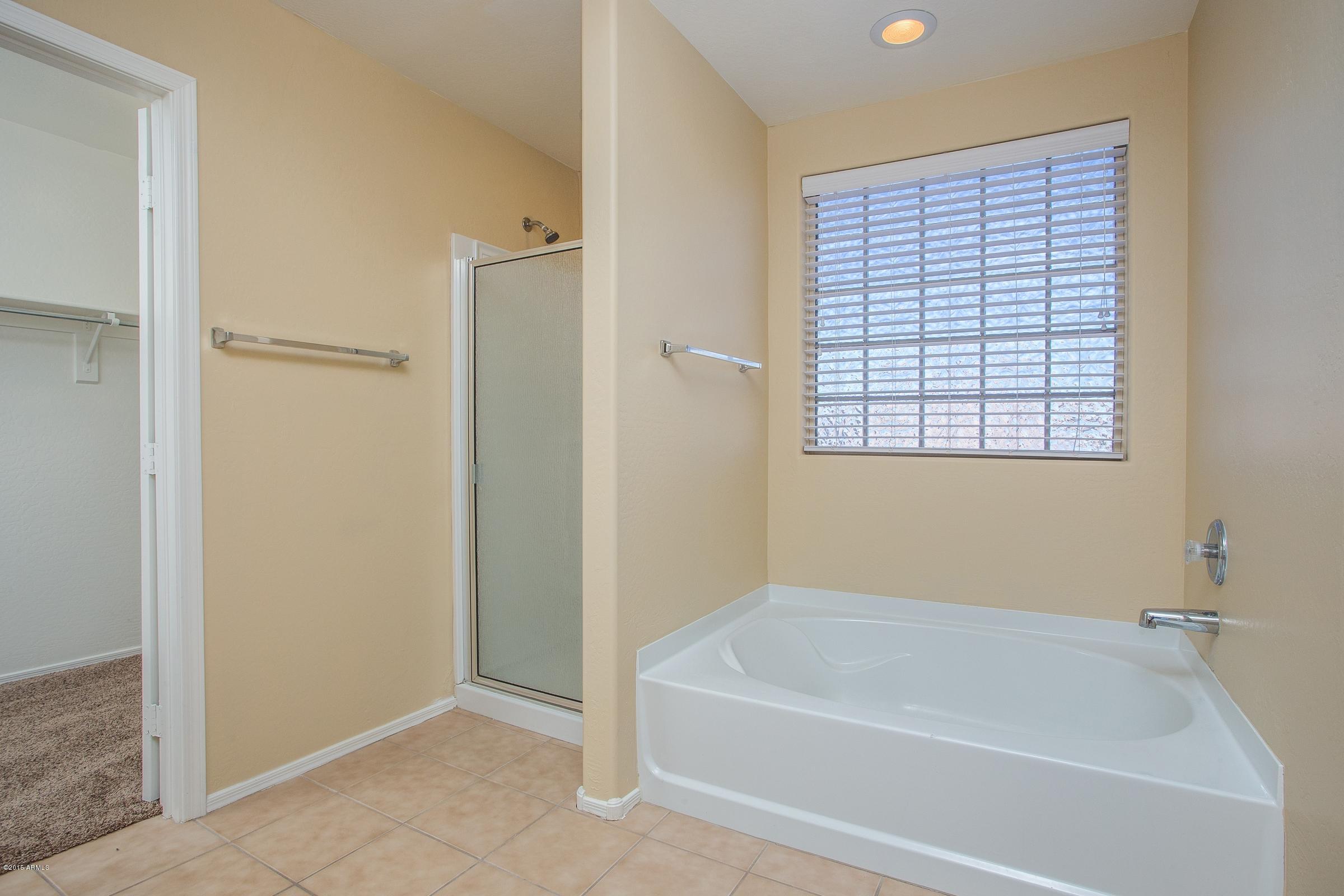 7326 West Darrel Road Laveen, AZ 85339 - Photo 10 of 15 a white bath tub sitting next to a window