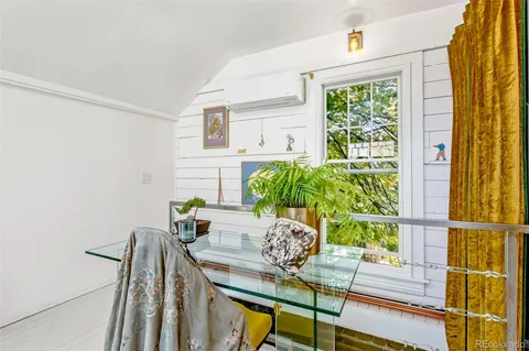 a view of a chairs and table in the balcony