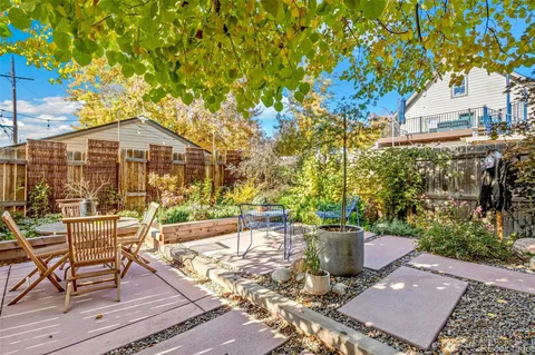 a view of a cafe with a table and chairs under an umbrella