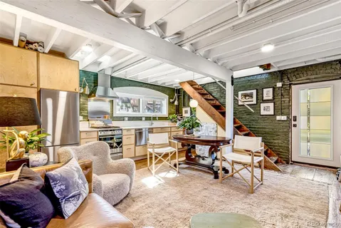a living room with furniture a fireplace and a floor to ceiling window