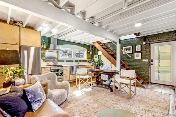 a living room with furniture a fireplace and a floor to ceiling window