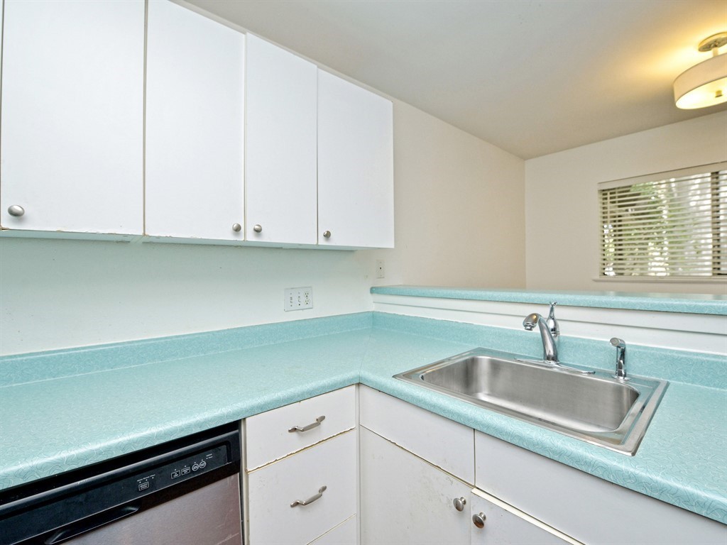 604 Franklin Boulevard, Unit A Austin, TX 78751 - Photo 10 of 20 a kitchen with granite countertop white cabinets and a sink