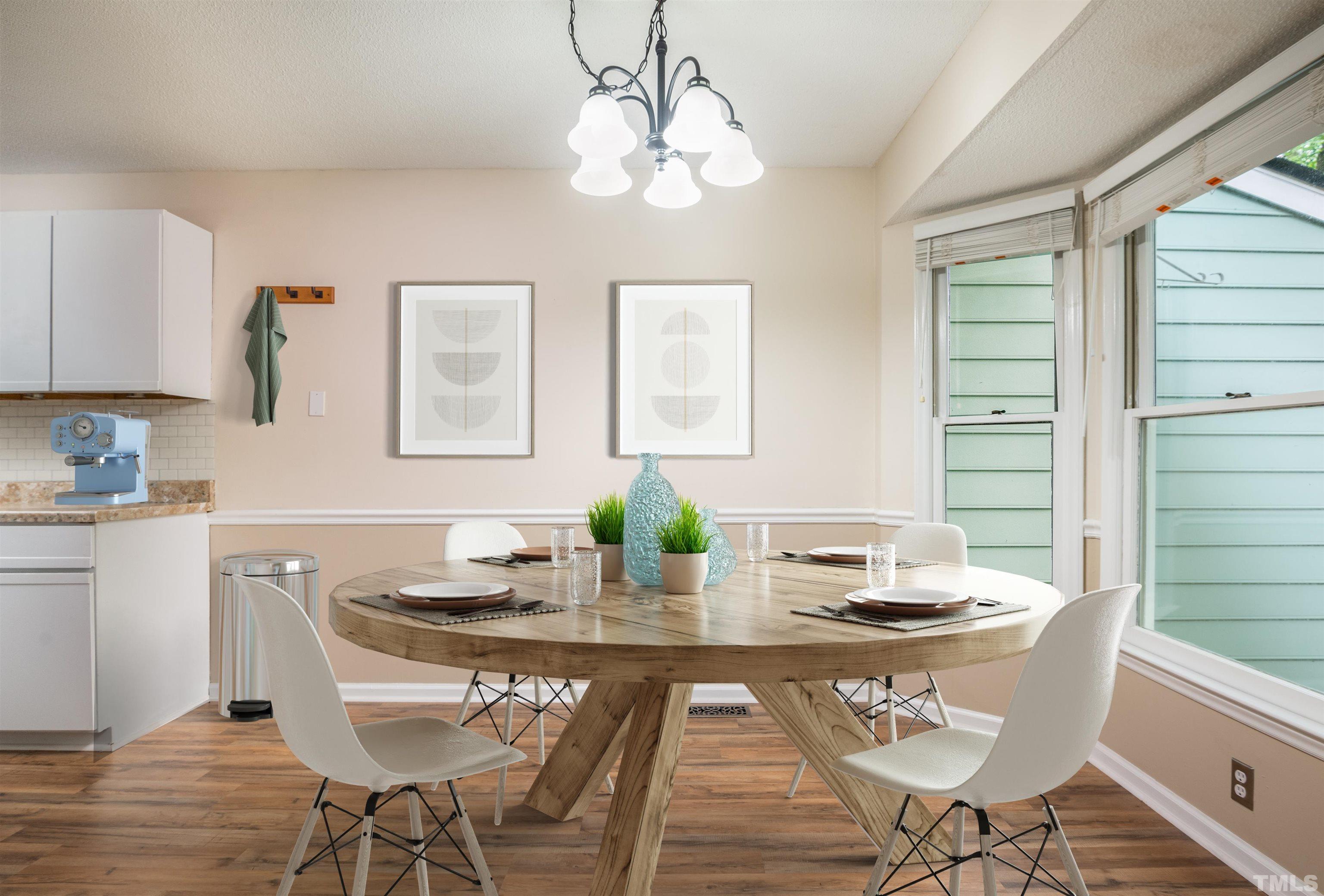405 Oak Run Drive Raleigh, NC 27606 - Photo 12 of 83 a view of a dining room with furniture window and wooden floor