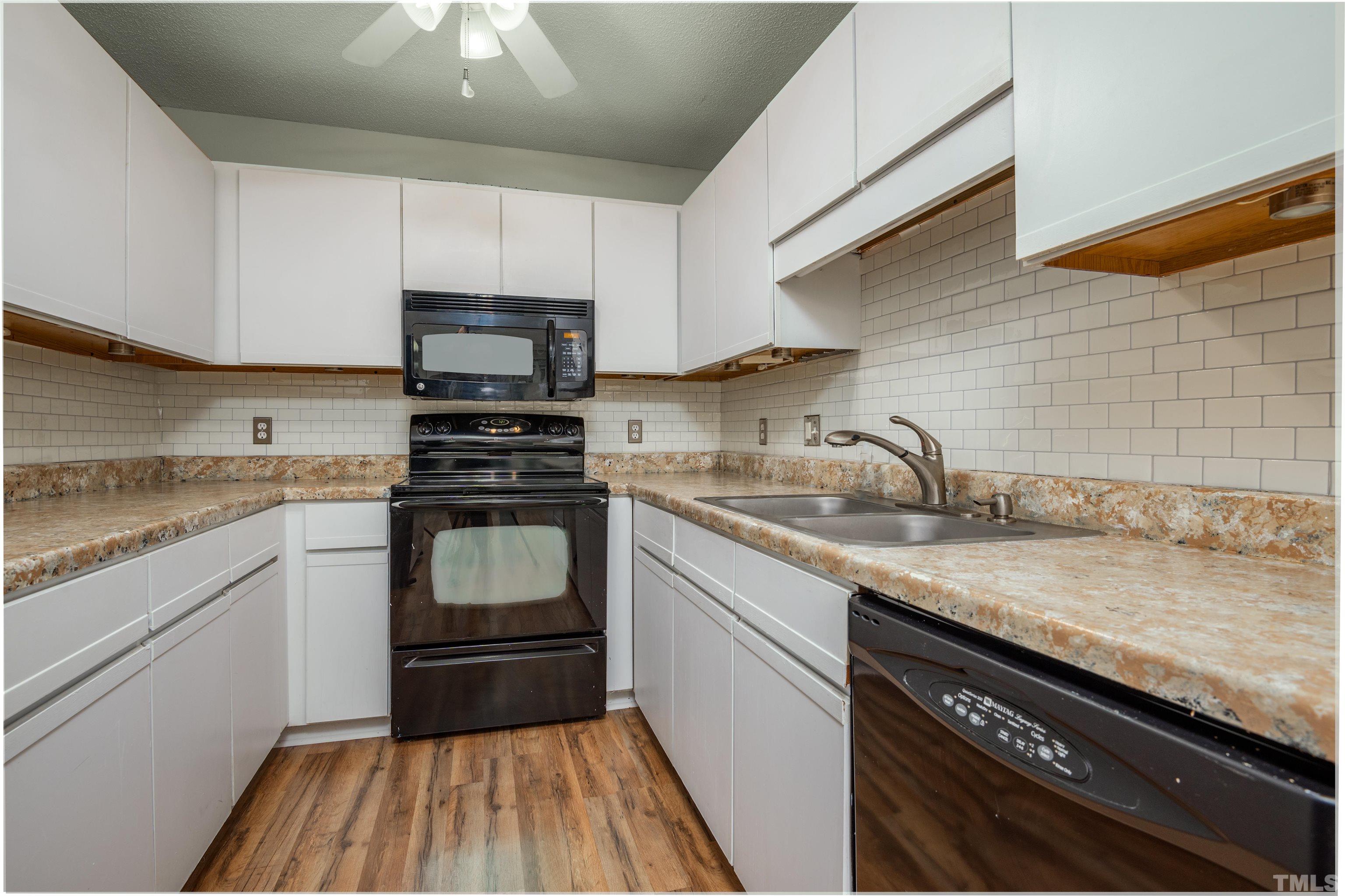 405 Oak Run Drive Raleigh, NC 27606 - Photo 17 of 83 a kitchen with granite countertop a sink cabinets and stainless steel appliances