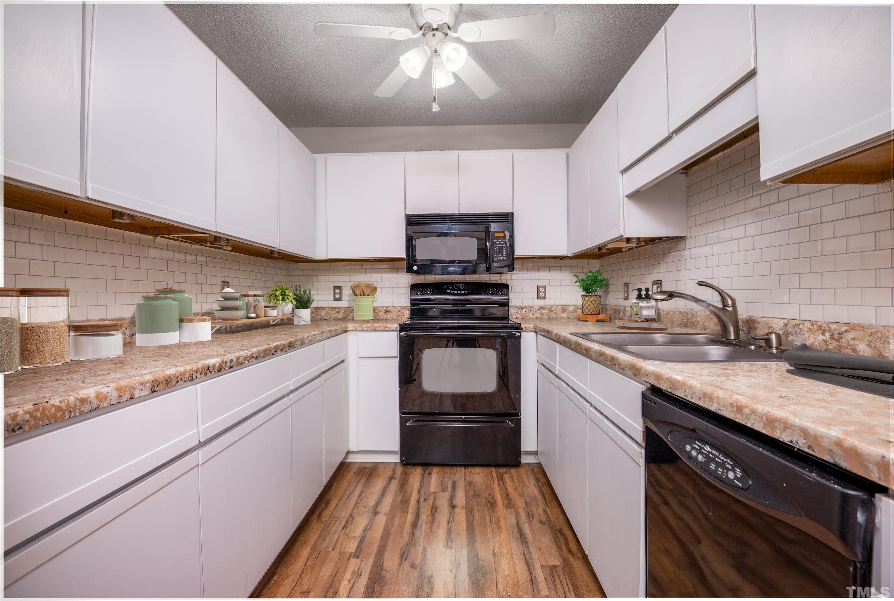 405 Oak Run Drive Raleigh, NC 27606 - Photo 20 of 83 a kitchen with granite countertop wooden cabinets and a stove top oven