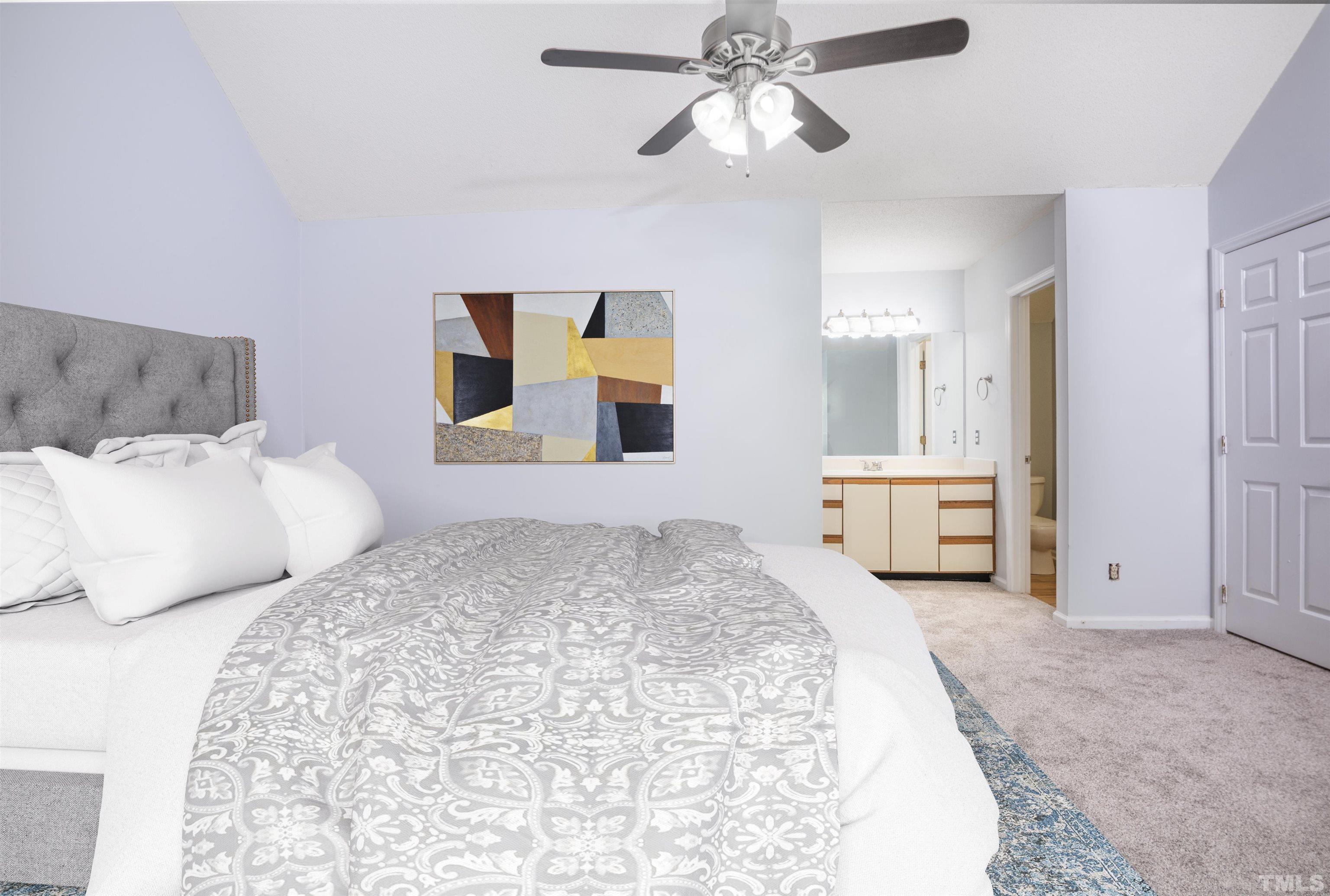 405 Oak Run Drive Raleigh, NC 27606 - Photo 34 of 83 a bedroom with a large bed and a chandelier