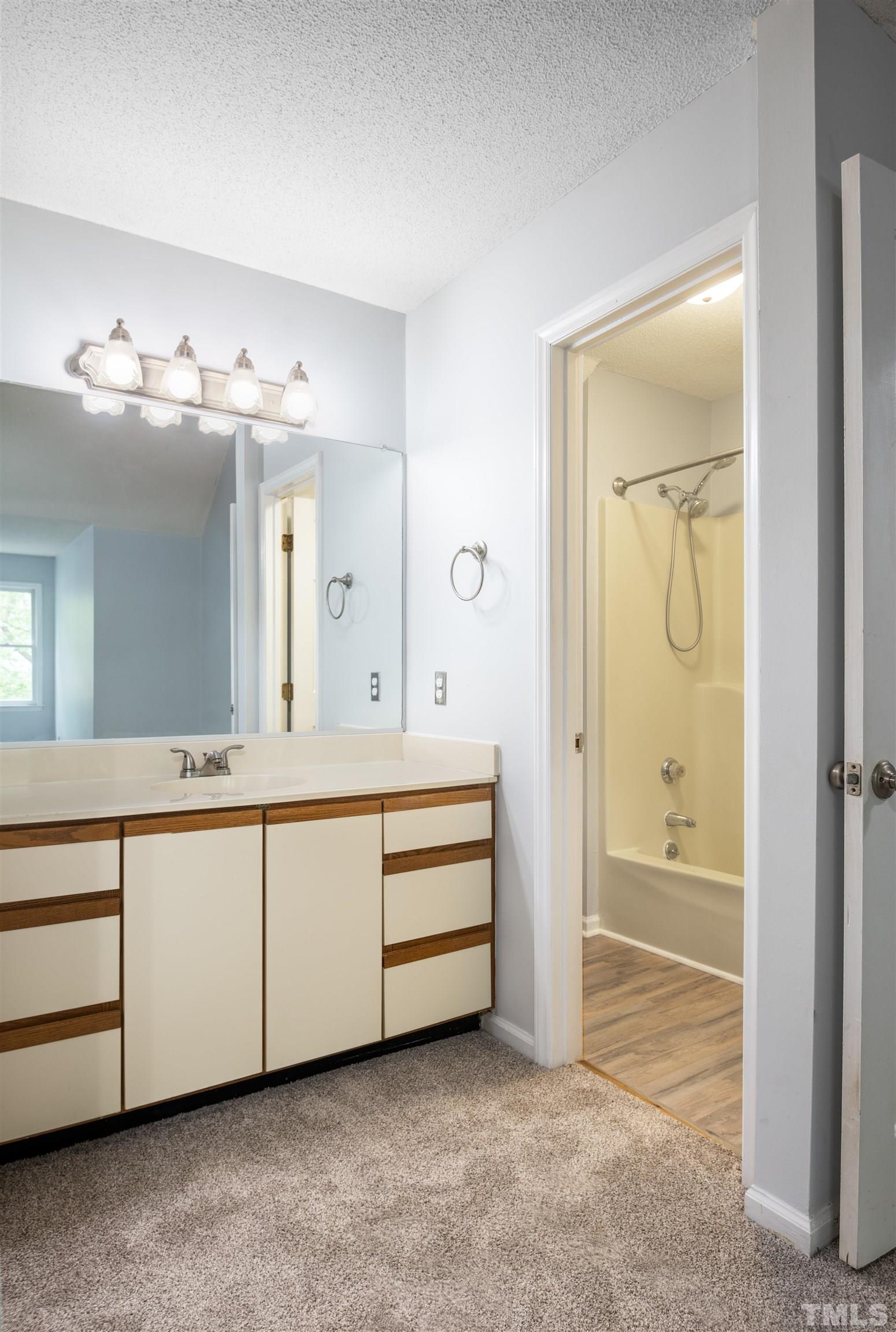 405 Oak Run Drive Raleigh, NC 27606 - Photo 39 of 83 a spacious bathroom with a double vanity sink and a mirror