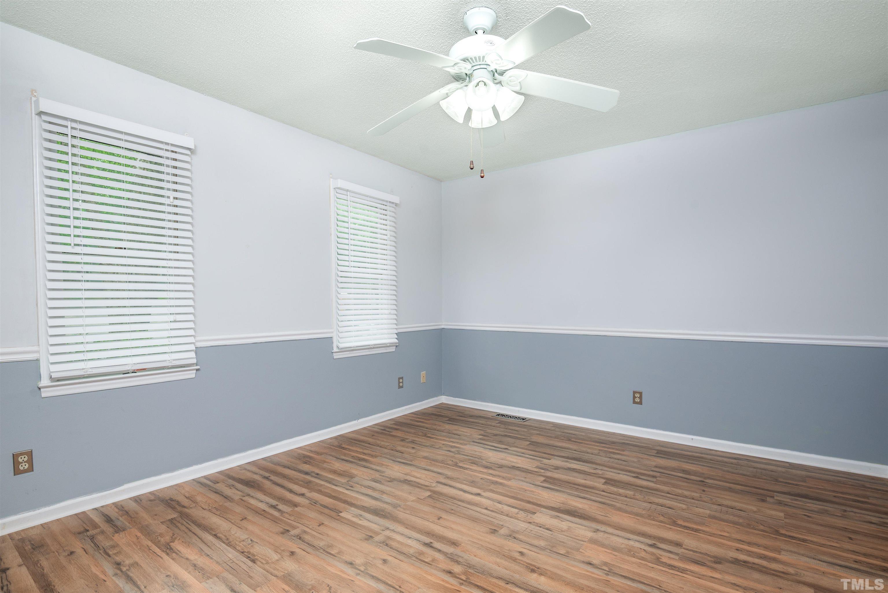 405 Oak Run Drive Raleigh, NC 27606 - Photo 42 of 83 an empty room with wooden floor and windows