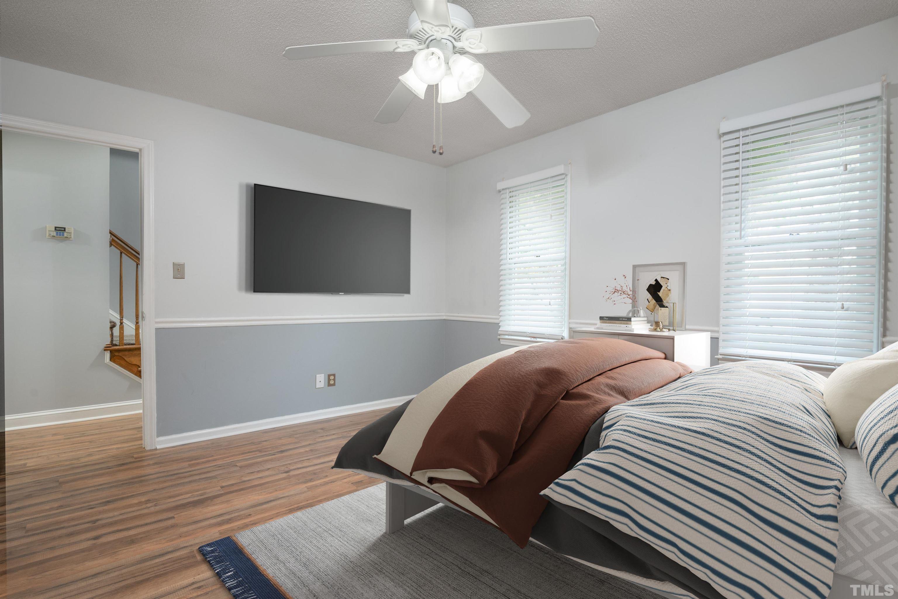 405 Oak Run Drive Raleigh, NC 27606 - Photo 47 of 83 a bedroom with a bed and a flat screen tv