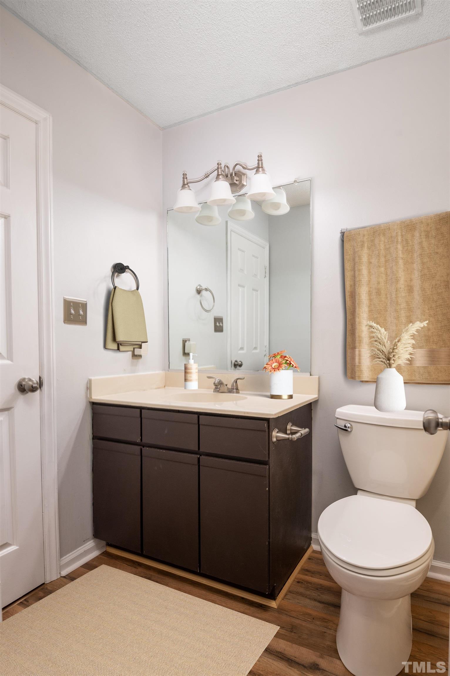 405 Oak Run Drive Raleigh, NC 27606 - Photo 49 of 83 a bathroom with a toilet sink and mirror