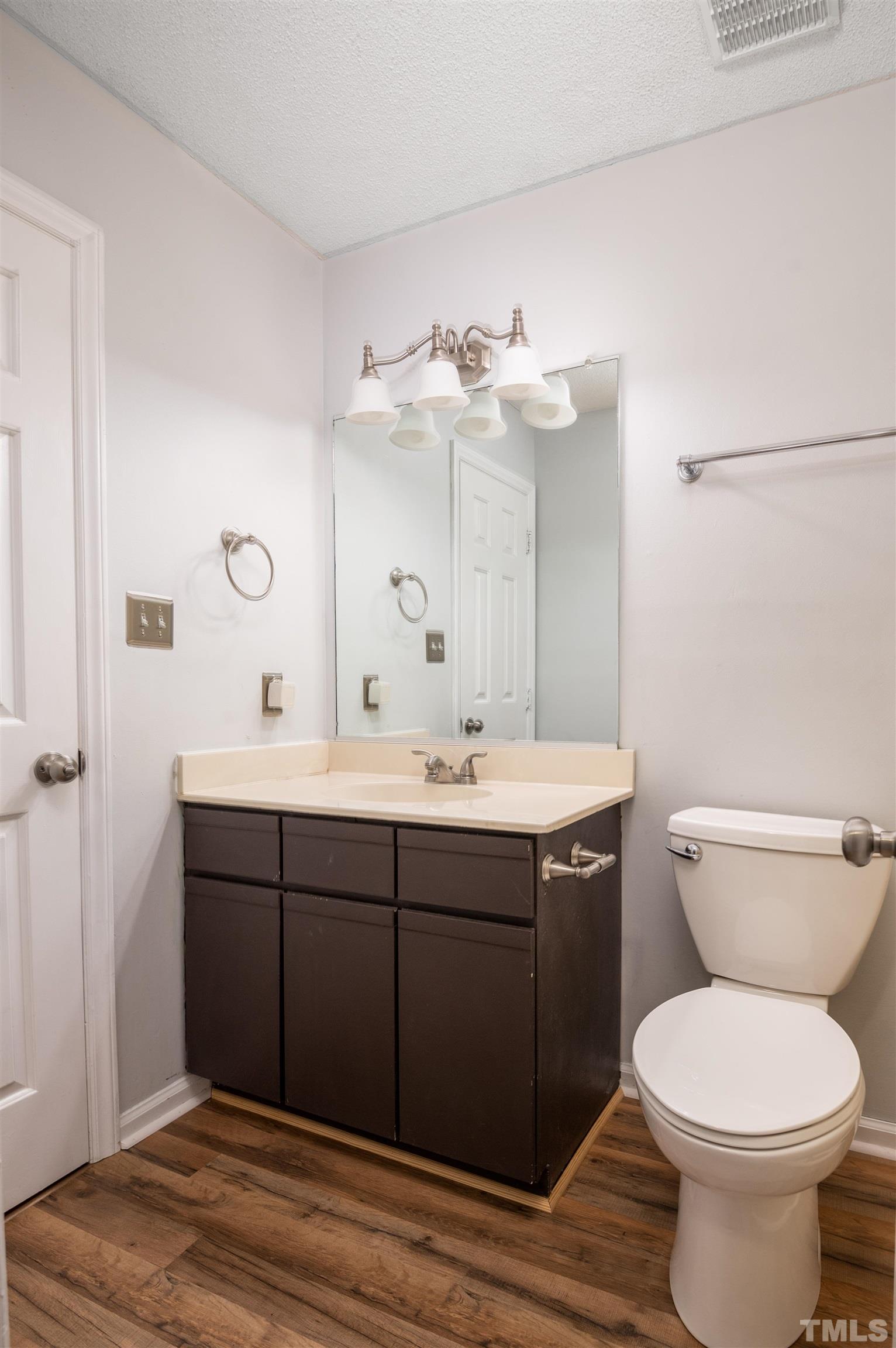 405 Oak Run Drive Raleigh, NC 27606 - Photo 50 of 83 a bathroom with a toilet sink and mirror