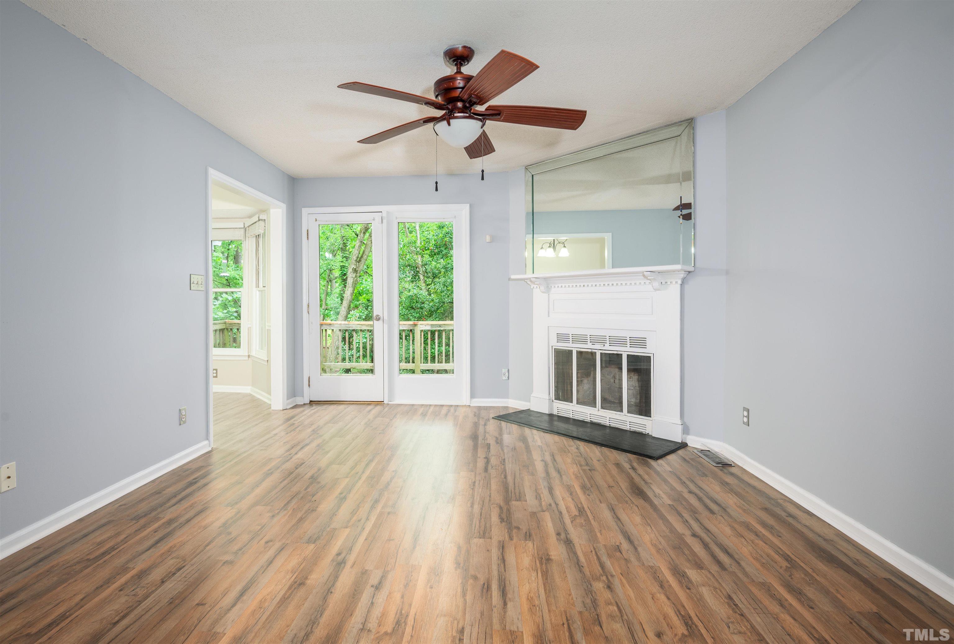 405 Oak Run Drive Raleigh, NC 27606 - Photo 5 of 83 a view of an empty room with wooden floor and a window