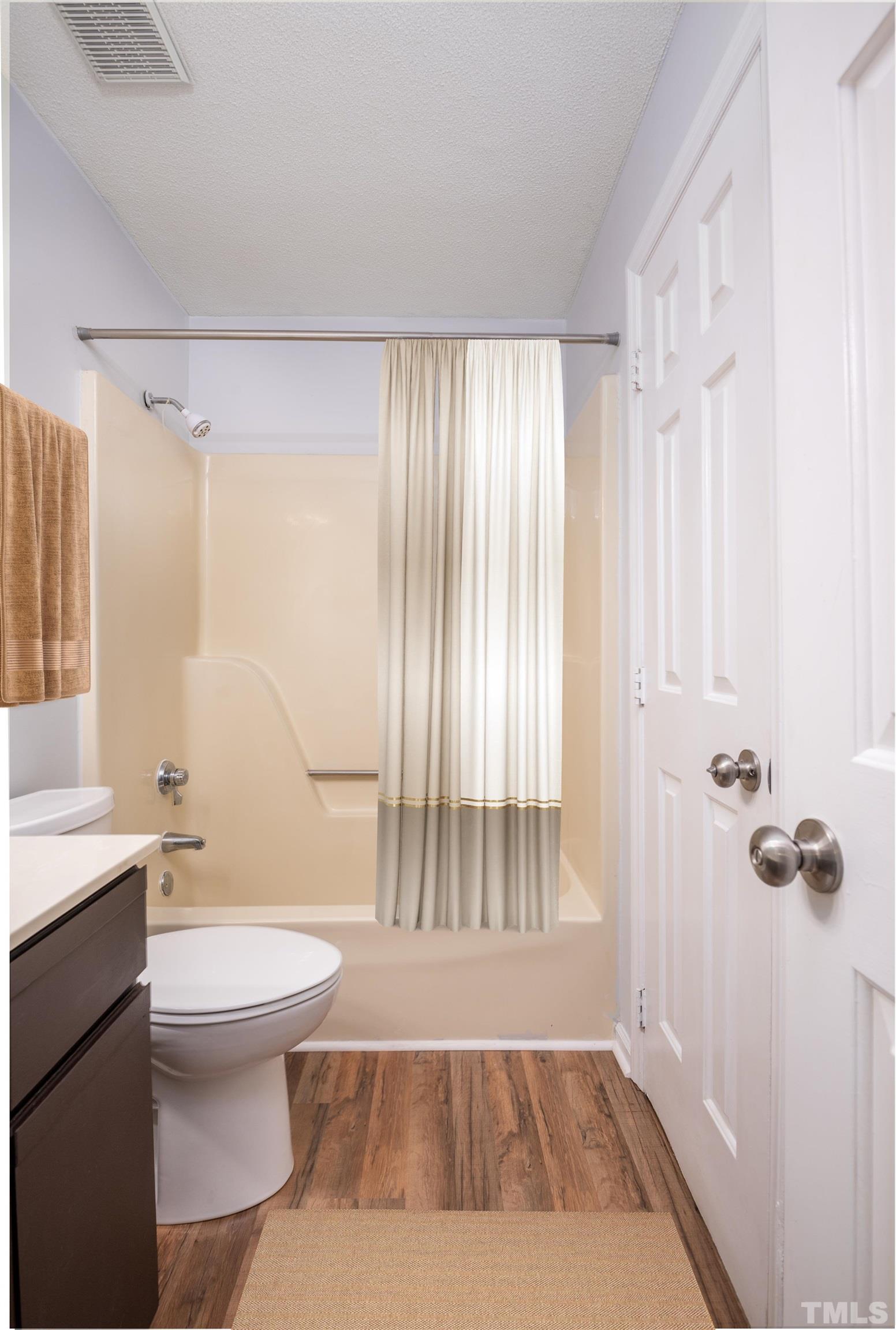 405 Oak Run Drive Raleigh, NC 27606 - Photo 51 of 83 a bathroom with a granite countertop sink a toilet a mirror and shower